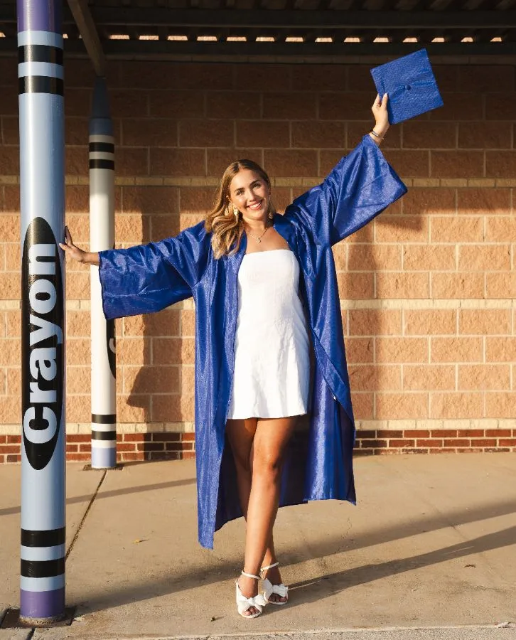 Senior celebrating in her graduation gown